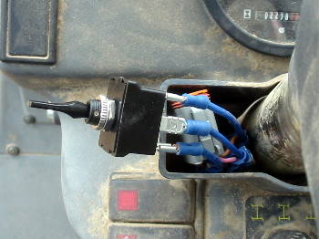Temp F/R fix - Mar 2010
To be able to used the Terex while we searched for parts to fix the shift lever,  I put in a $4.00 Radio Shack switch.  The rest of the $10 went to connectors that I was out of.
Keywords: Switch