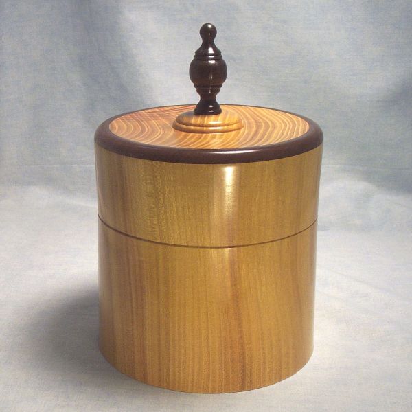 Osage Orange Box - 6 inch Diameter 020
View 2 - Osage Orange Turned Lidded Box with walnut rim on lid and walnut finial.  6 inch diameter, 6 1/4 inch tall without finial and 9 inches tall to top of finial. 
