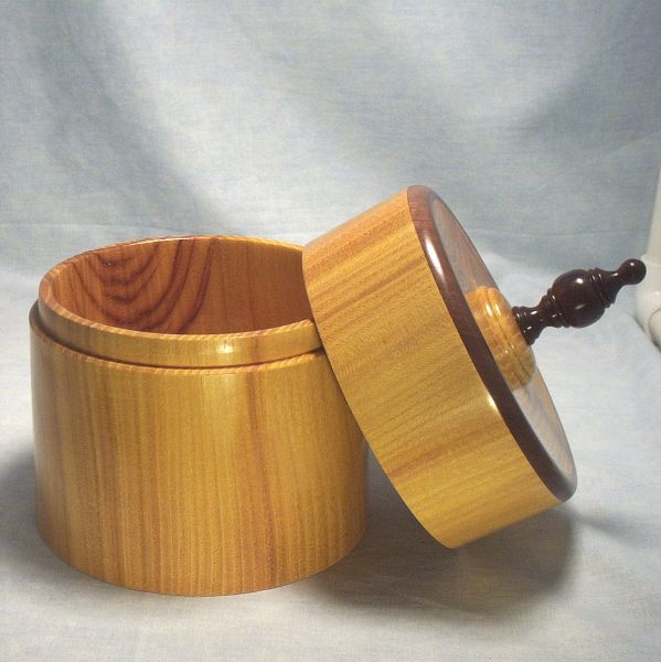 Osage Orange Box - 6 inch Diameter 021
View 3 - Osage Orange Turned Lidded Box with walnut rim on lid and walnut finial.  6 inch diameter, 6 1/4 inch tall without finial and 9 inches tall to top of finial. 

