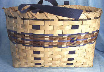 Donna's Tote Basket 004
Donna began weaving baskets 10 or 15 years ago and really enjoys it.  Her basket weaving skills amaze me and I love the creations she comes up with. I've loaded 4 different Tote  Baskets, each with a different color scheme.  A Tote Basket is used kind of like an attache case. You carry things in it whereever you go. Donna uses hers everyday and after years of use, it has that "worn" look, but still looks good.  
