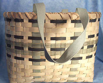 Donna's Tote Basket 002
Donna began weaving baskets 10 or 15 years ago and really enjoys it.  Her basket weaving skills amaze me and I love the creations she comes up with. I've loaded 4 different Tote  Baskets, each with a different color scheme.  A Tote Basket is used kind of like an attache case. You carry things in it whereever you go. Donna uses hers everyday and after years of use, it has that "worn" look, but still looks good.  
