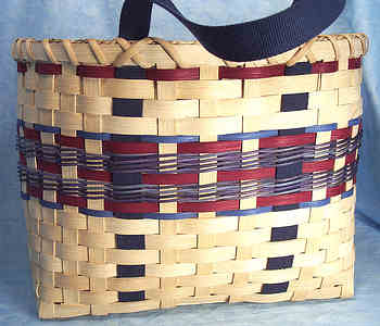 Donna's Tote Basket 001
Donna began weaving baskets 10 or 15 years ago and really enjoys it.  Her basket weaving skills amaze me and I love the creations she comes up with. I've loaded 4 different Tote  Baskets, each with a different color scheme.  A Tote Basket is used kind of like an attache case. You carry things in it whereever you go. Donna uses hers everyday and after years of use, it has that "worn" look, but still looks good.   
