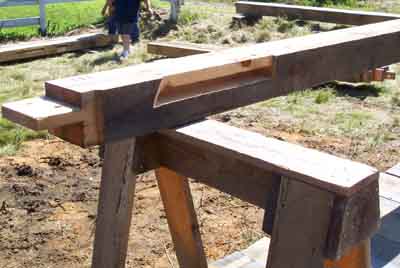 Long curved brace mortise in tie beam
