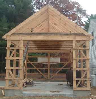 Photo showing door way to small pole barn.
This pole barn is about 16' wide and 30' long. It has one big door and one side man size door.
