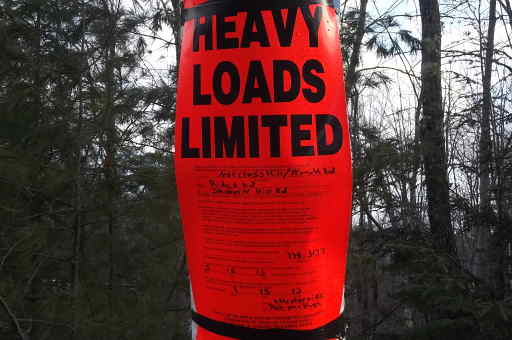 posted road sign on jan 15 2013
in Maine the raods are posted for weight. these are put on back roads. the roads can not take the weight of a loaded log truck. Most times the signs are put up in april and by mid May the postings come down. Warm spell in Jan brought the posting out. If the temps are below freezing the trucks can haul wood.

