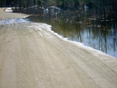 meadow,dirt road
water over the road,only a few inches

