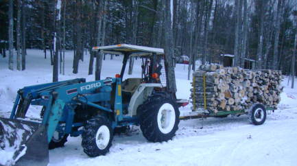 40 hp ford with woods trailer
this 10 foot trailer will hold almost a cord.i park this beside my furnace and take the wood off as needed to fill the furnace.wood is cut 4 foot except for the big stuff.that is cut 2 foot.
