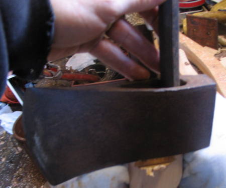 making an axe handle
Pushing handle out of axe head .

