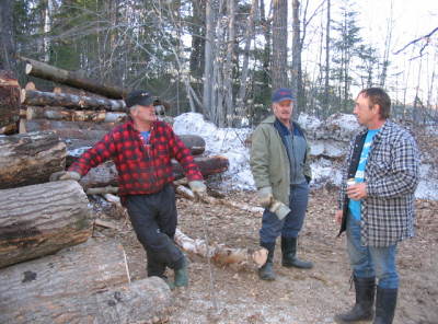 Helpers
 My brother Norman , to the right  and friends  Leo , and his twin Lucien , Norm has been slashing for me while the twins mesured and cut the logs and gave general help around the machine when I got to the landing with the skidder.
