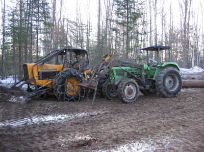 machine help 28-03-2006
%40 John Deere and Deuzt 4 X 4 tractor to place the logs ... Nice to have them around to move and place the logs . 
