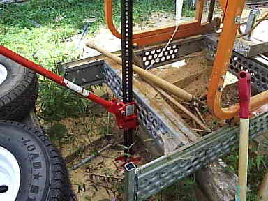 Farm Jack used to lift saw bed to remove axle stubs
