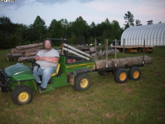Cousin Kenny with my Gator and JMS logging trailer with red oak
