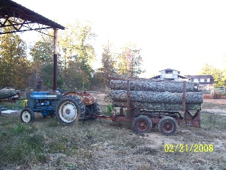 Little Ford with tie logs
Bobby and I built this trailer to bring logs to the mill...It was origionally an ole pulp wood trailer..that halled 5 ft length wood...It had been sitting in the weed/woods for years..we changed the configuration ...
