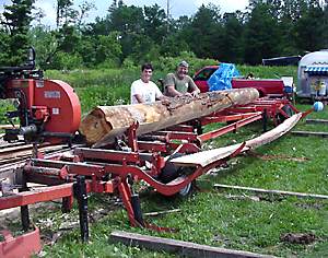 Hydraulic Extensio on WM mill.
Chris Callahan of Windsor Locks, Conn., and Jim Clarke, founder of the Massachusetts Portable Sawmill Association, next to a 24' log being sawn. Jim added an extension to his Wood-Mizer that allows him to saw up to 45' logs.

