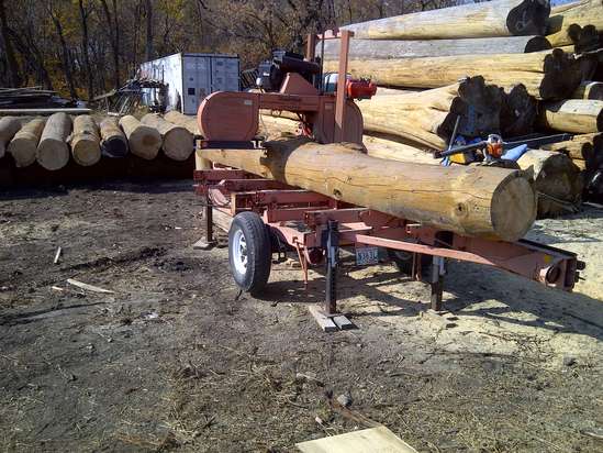 Milling red pine, small stack of cedar in background
