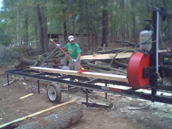 Nick helps brush sawdust off
My helper Nick brushes sawdust off the cant. I've been told this is a good thing to do to improve drying and reduce mold, rot, etc.
Keywords: turner band sawmill bandsaw cant broom brush sawdust