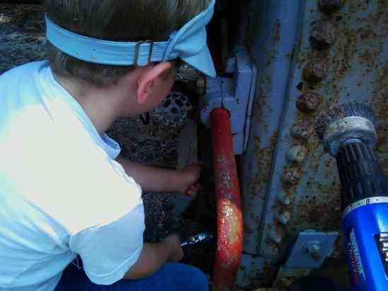 My nine year old grandson helping me change the hand hole gaskets in the boiler.
